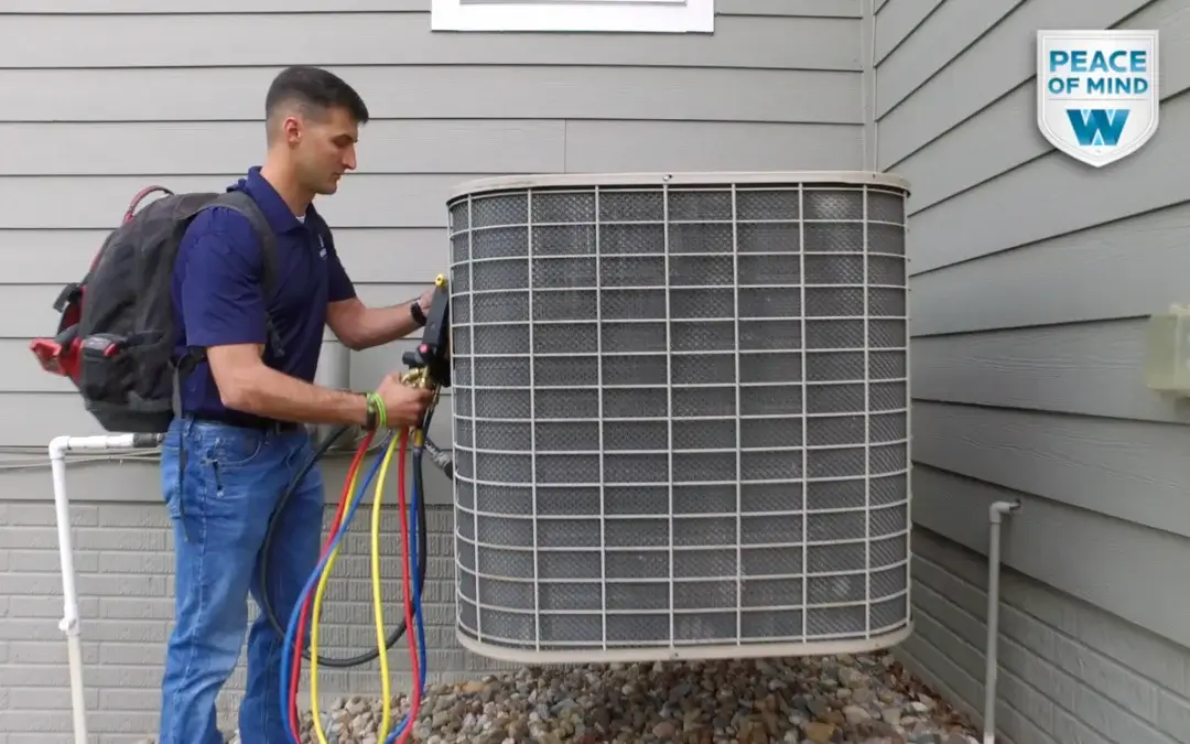 hvac tech works on an outdoor system